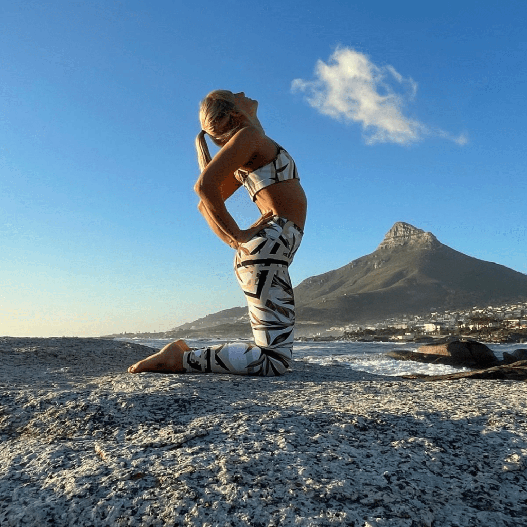 Woman doing yoga near mountain